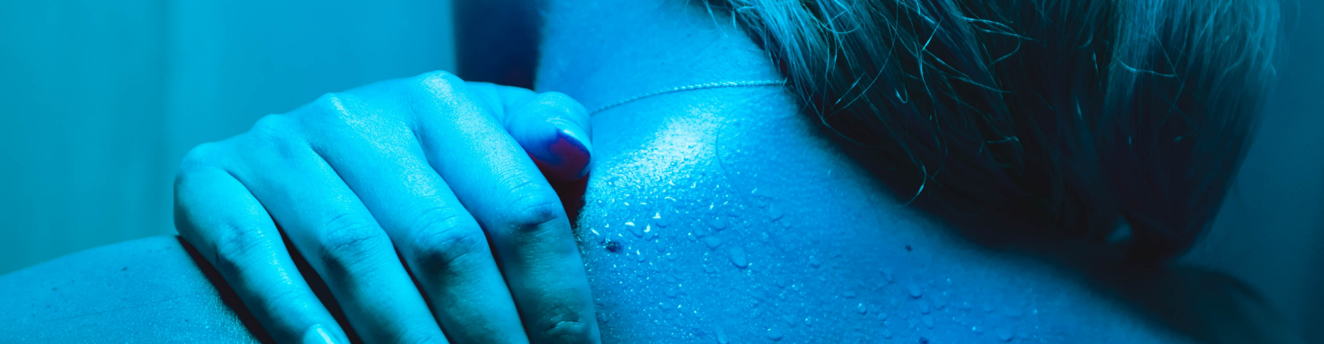 closeup of a woman's back sweating in a sauna